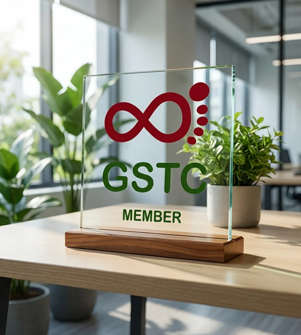GSTC Member glass plaque on walnut base in modern sustainable office with green plants